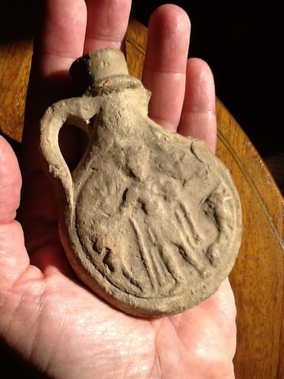 Pilgrim flask representing St. Menas with two camels. From the area of Alexandria, Egypt. Common from 6th-7th cent., clay, private collection, 14 x 7 cm, photo © George Greenia.